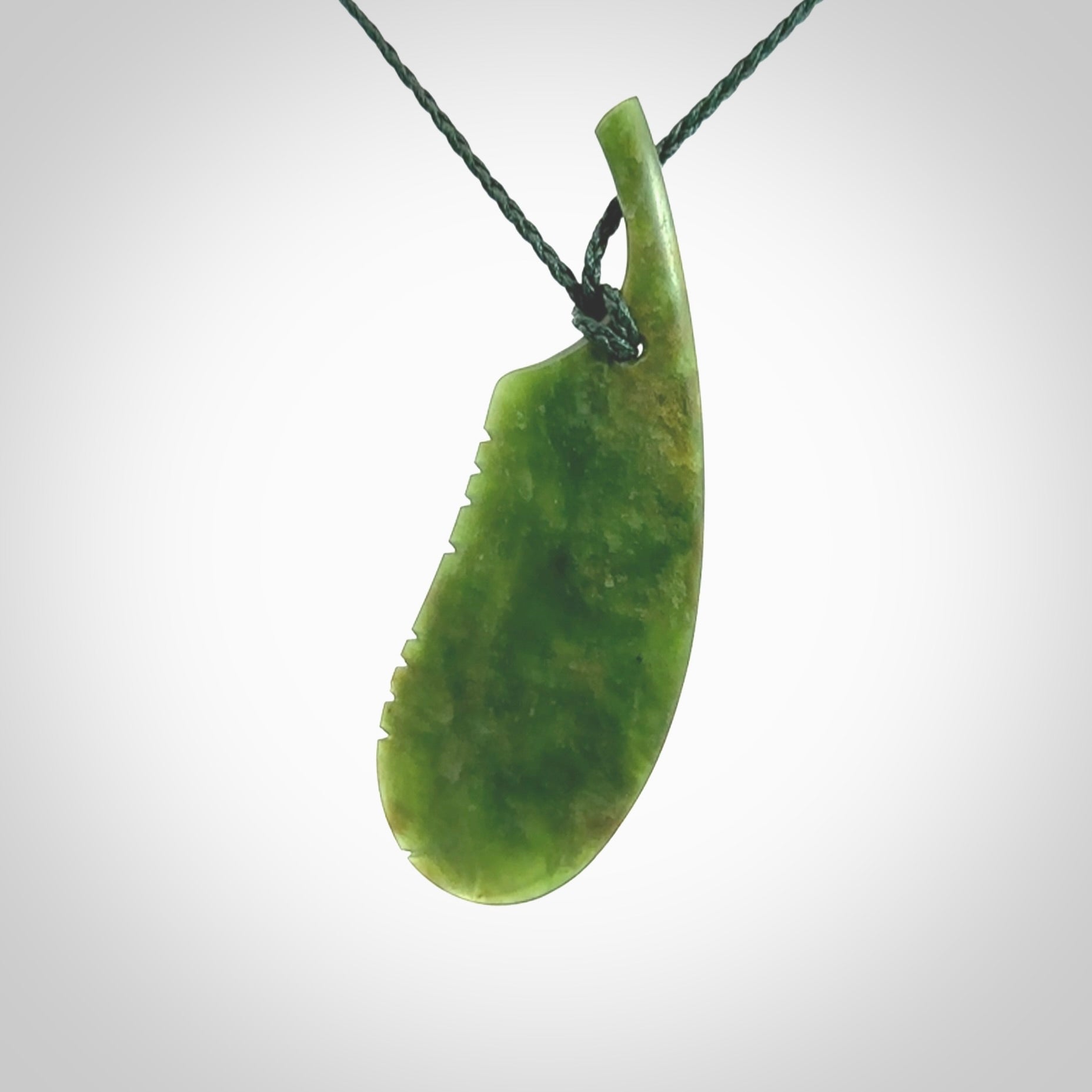 A hand carved large New Zealand Flower Jade feather necklace. The cord is a green colour and is an adjustable length. A large sized hand made Jade feather necklace by New Zealand artist Kerry Thompson. One off work of art to wear.