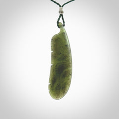 A hand carved large New Zealand Totoweka Jade feather necklace. The cord is a green colour and is an adjustable length. A large sized hand made Jade feather necklace by New Zealand artist Kerry Thompson. One off work of art to wear.