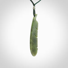 A hand carved large New Zealand Totoweka Jade feather necklace. The cord is a green colour and is an adjustable length. A large sized hand made Jade feather necklace by New Zealand artist Kerry Thompson. One off work of art to wear.