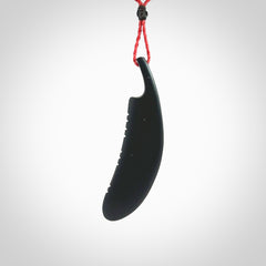 A hand carved large Wyoming Black Jade feather necklace. The cord is a red colour and is an adjustable length. A large sized hand made Black Jade feather necklace by New Zealand artist Kerry Thompson. One off work of art to wear.