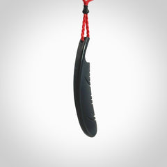 A hand carved large Wyoming Black Jade feather necklace. The cord is a red colour and is an adjustable length. A large sized hand made Black Jade feather necklace by New Zealand artist Kerry Thompson. One off work of art to wear.