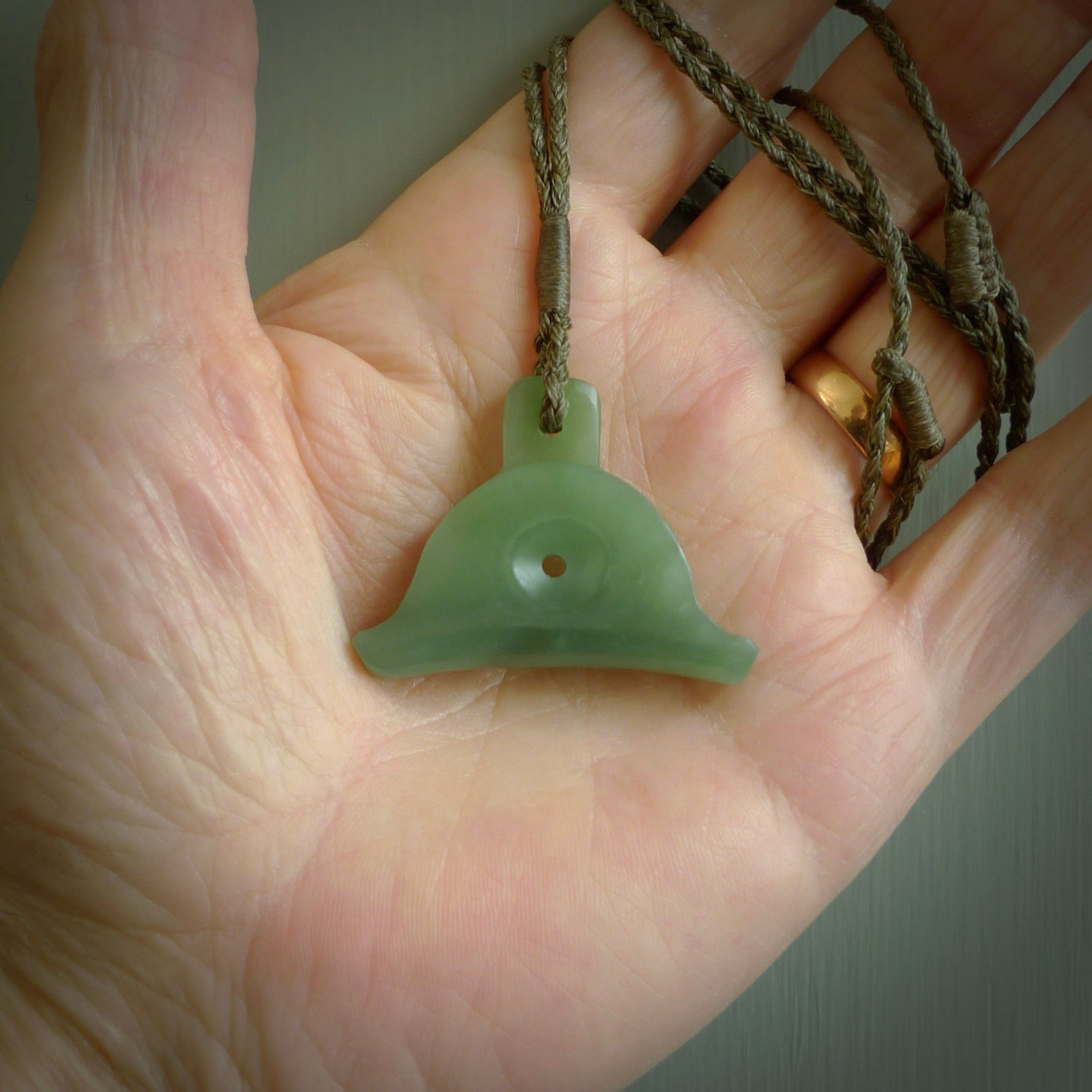 Hand carved New Zealand jade dog whistle. Carved for NZ Pacific by master carver Ross Crump. Jade dog whistle pendant.