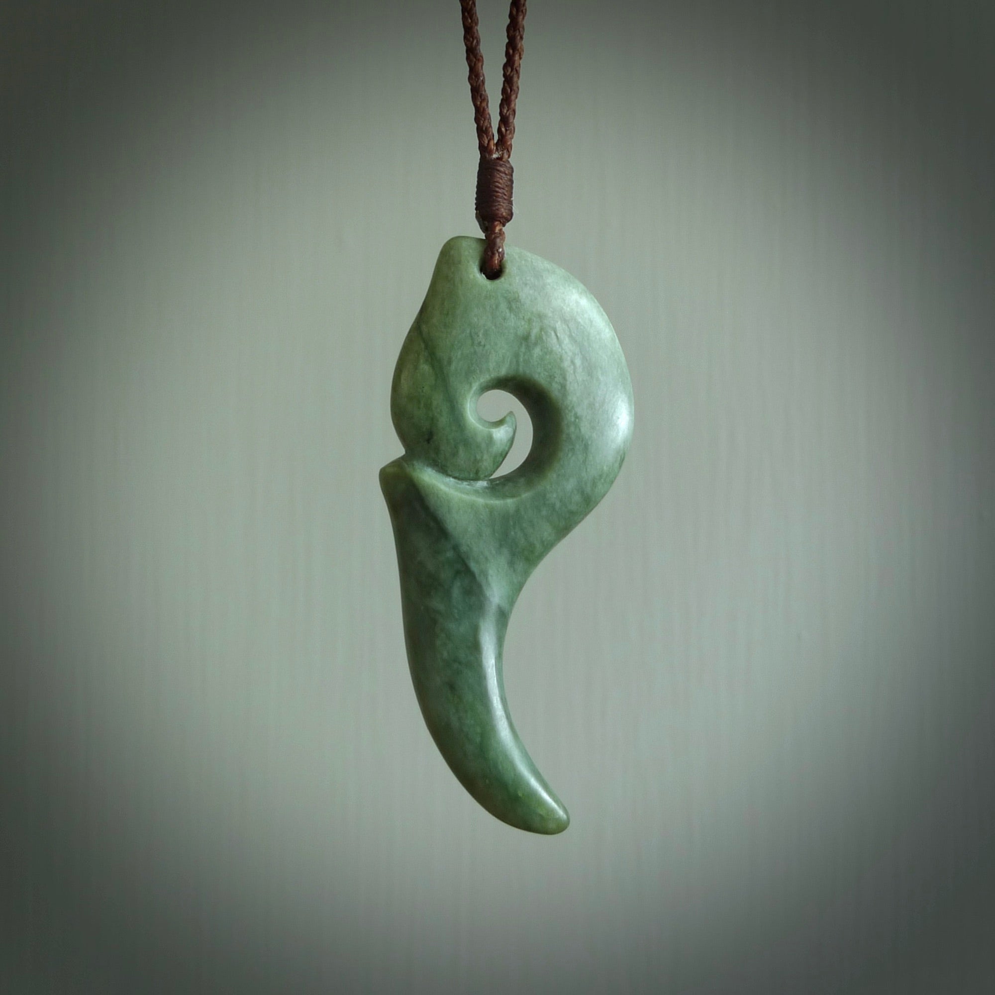 Hand carved huia bird skull made from New Zealand Marsden Jade pendant. Carved for NZ Pacific by Kyohei Noguchi. This is a contemporary piece of jewellery that is carved with intricate detail and clearly shows a beautiful bird skull. We ship this free worldwide with DHL Express Courier.