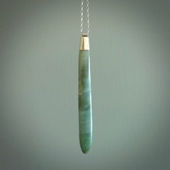 This picture shows a hand carved Inanga Pounamu, jade drop pendant with sterling silver cap and chain. The jade is a very dark green with a shimmer of light blue tones in the stone. It is suspended from a sterling silver clasp and we supply a sterling silver chain. Delivery is free worldwide.