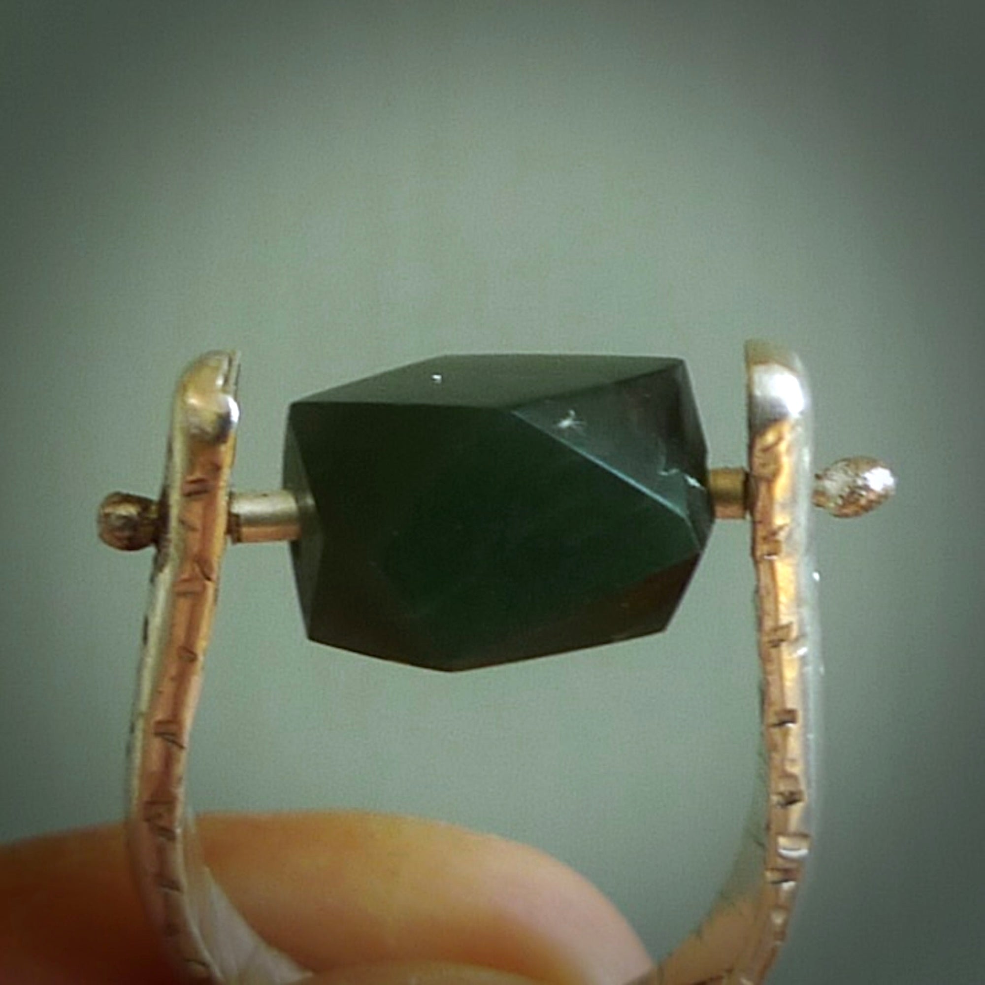 This is a handcrafted New Zealand Pounamu, Jade and sterling silver ring. This is a solid little work of art. We ship this worldwide for free and are happy to answer any questions that you may have about these or other products on our website. Hand made by Ana Krakosky.