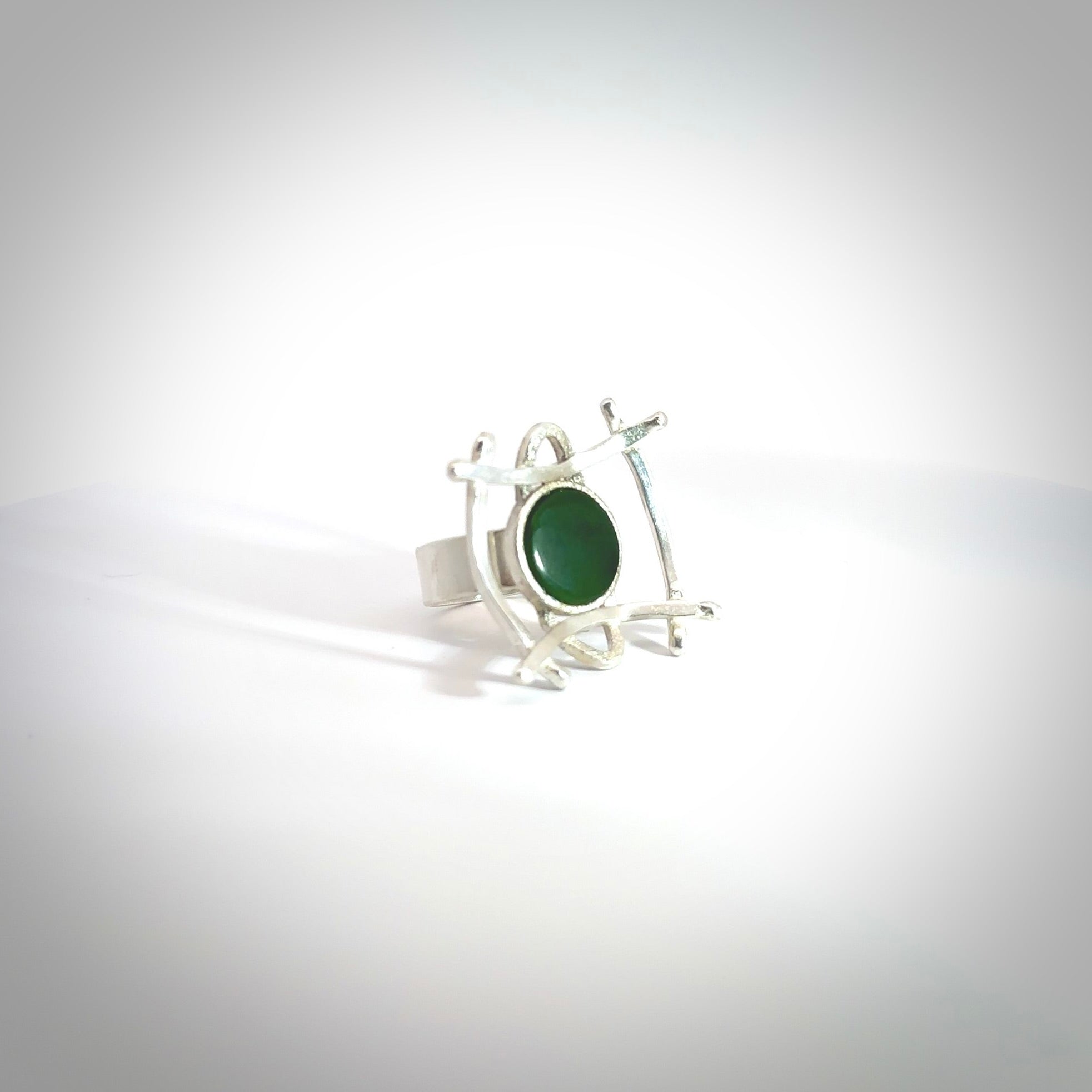 This is a handcrafted New Zealand Pounamu, Jade and sterling silver ring. This is a solid little work of art. We ship this worldwide for free and are happy to answer any questions that you may have about these or other products on our website. Hand carved by Ana Krakosky. Delivered with Express Courier in a woven kete pouch.