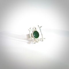 This is a handcrafted New Zealand Pounamu, Jade and sterling silver ring. This is a solid little work of art. We ship this worldwide for free and are happy to answer any questions that you may have about these or other products on our website. Hand carved by Ana Krakosky. Delivered with Express Courier in a woven kete pouch.