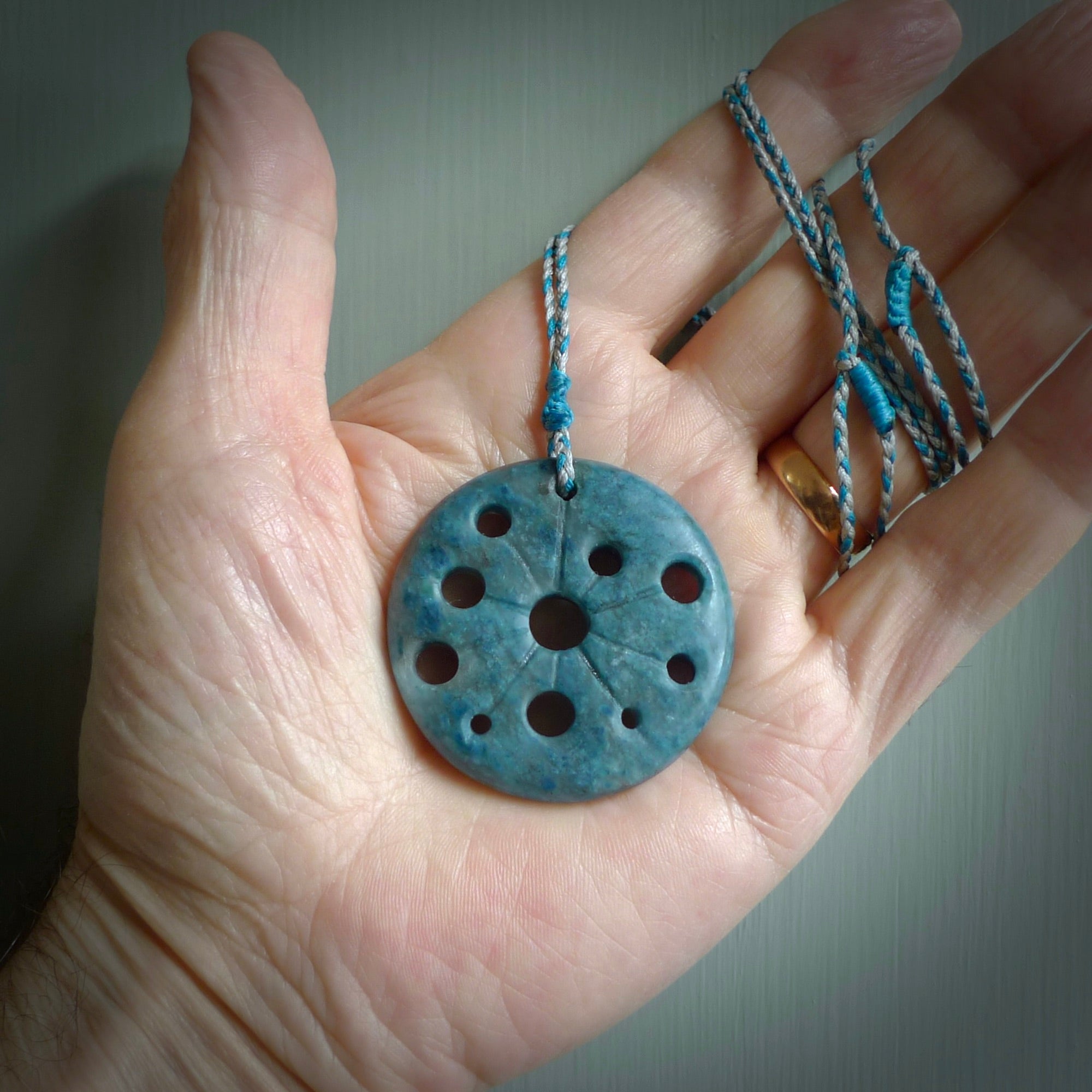 This is a handcrafted aotea stone disc pendant. This is a solid contemporary work of art. We ship this worldwide express courier and are happy to answer any questions that you may have about these or other products on our website. Hand made by Ana Krakosky.