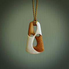 A hand carved bone contemporary, intricate, twist pendant. The cord is a tan colour and is adjustable. A medium sized hand made contemporary necklace by New Zealand artist Tonijae Brockway. Tonijae has stained parts of the bone which really add to the dimension of this pendant. One off work of art to wear.