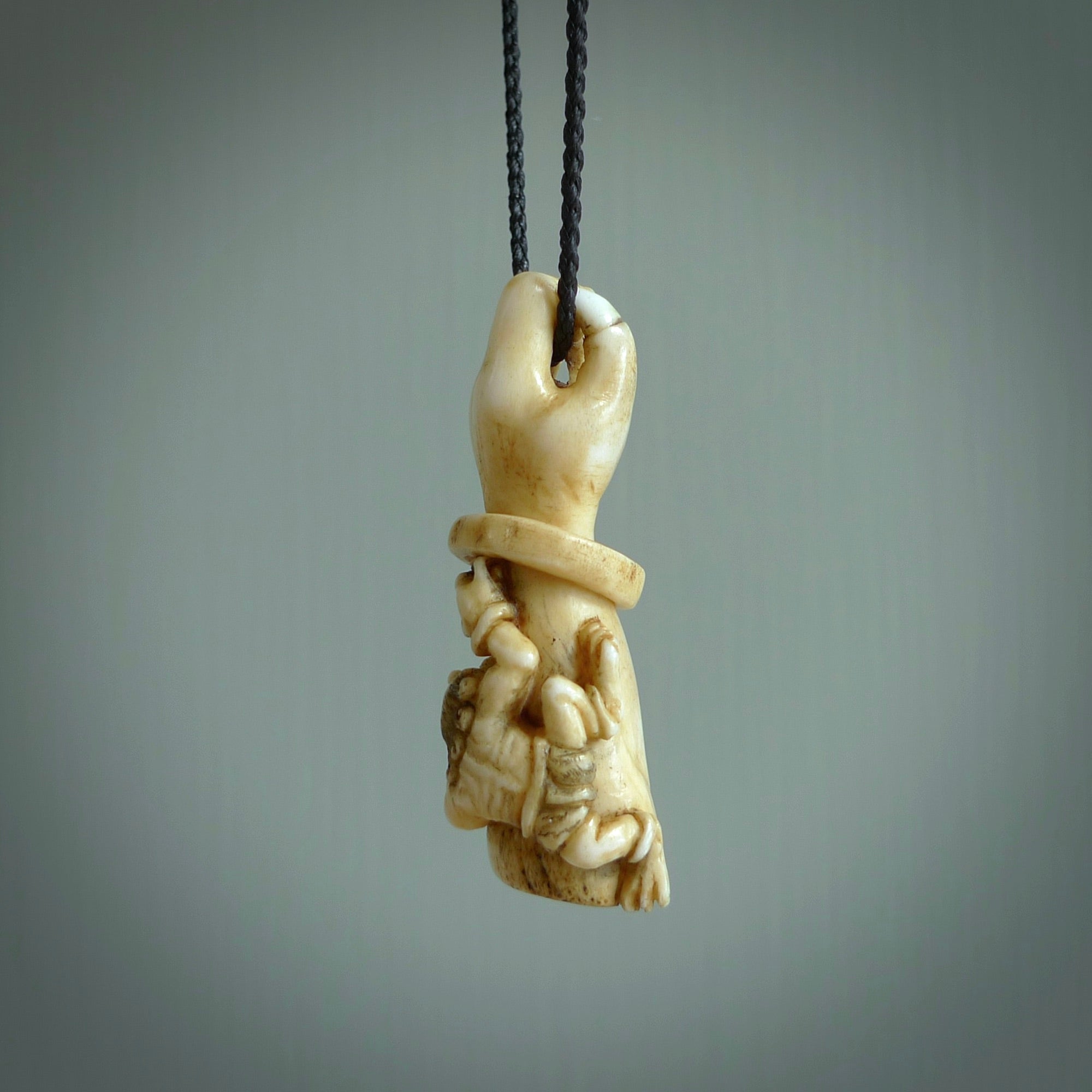 Hand carved Rashōmon Pendant. Made from Red Deer antler in New Zealand. Unique Japanese necklace hand made from deer antler by master bone carver Fumio Noguchi. Spectacular collectable work of art, made to wear. One only pendant, delivered to you at no extra cost with express courier.