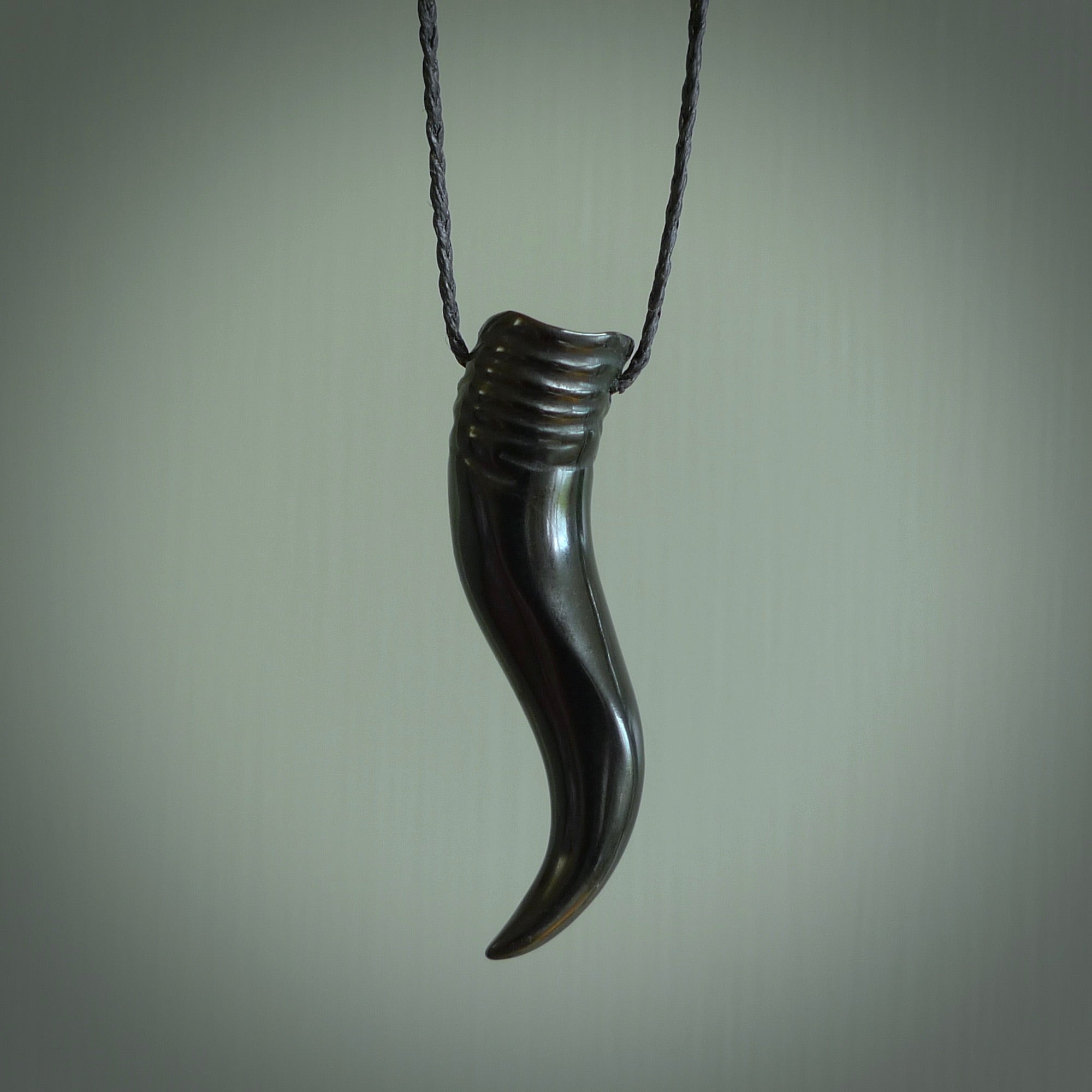 Black jade Italian Horn pendant. Handmade jade jewellery made by NZ Pacific and for sale online. Black Jade Goat Horn pendant worn for protection over evil eye, bad luck and promotes fertility. Ancient symbolic necklace hand made in Australian Black Jade.