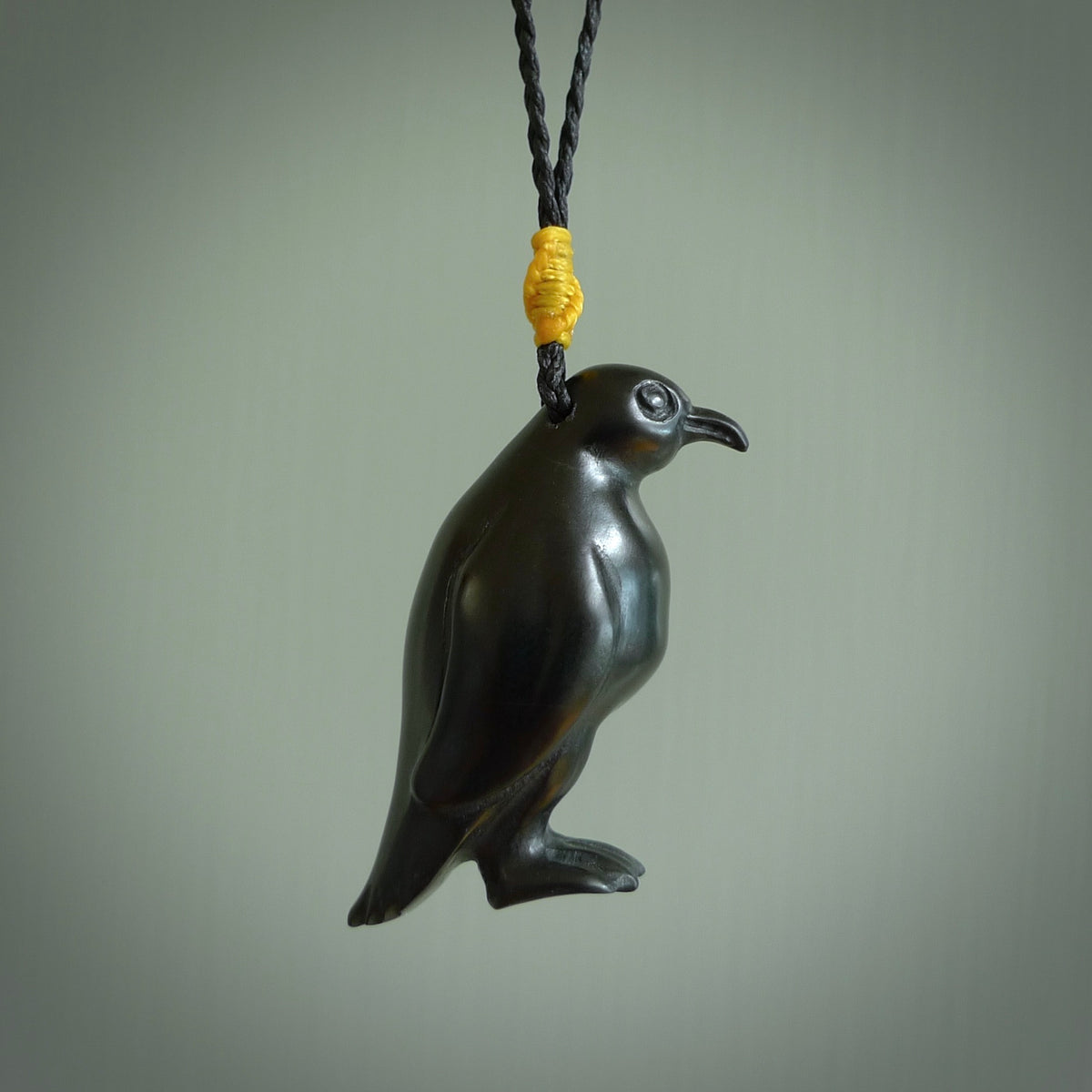 This pendant is a hand carved YELLOW EYED penguin. We've carved this from a lovely piece of black jade and we provide it with a hand plaited cord. Shipping is free worldwide.