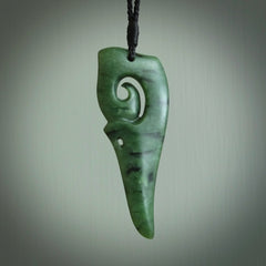 Hand carved huia bird skull made from New Zealand Marsden Jade pendant. Carved for NZ Pacific by Kyohei Noguchi. This is a contemporary piece of jewellery that is carved with intricate detail and clearly shows a beautiful bird skull. We ship this free worldwide with DHL Express Courier.