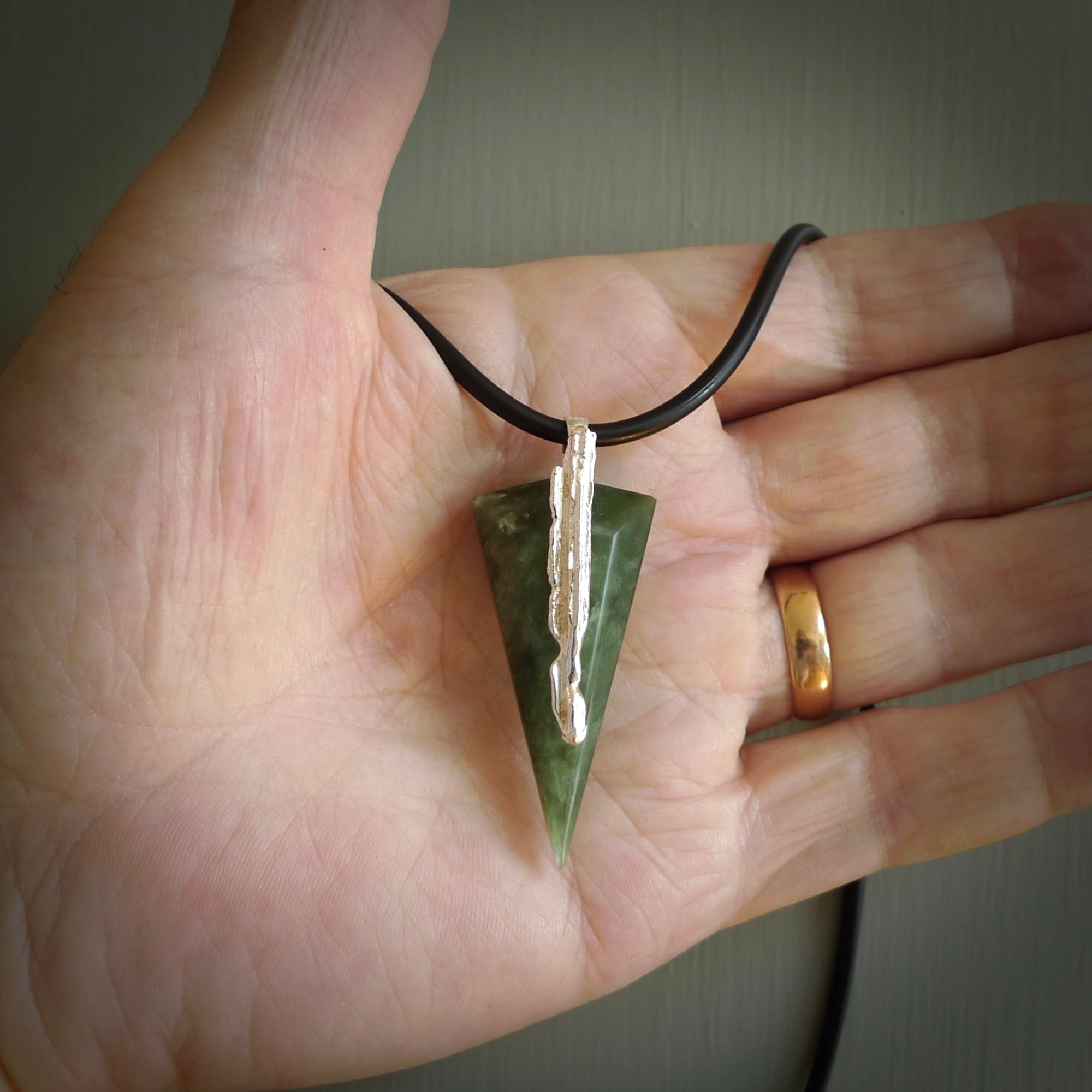 A photo of a New Zealand Jade drop pendant with sterling silver. This is a stylish statement piece - hand crafted here in New Zealand by Ana Krakosky. Unique Art to Wear. Gifts for all lovers of hand made Art to Wear.