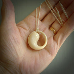 A hand carved masterpiece. A complex contemporary drop pendant carved from bone by Yuri Terenyi for NZ Pacific. This is a true piece of wearable art which is collectible. A one-off masterpiece and quite unique. Delivered with adjustable ice white necklace cord.