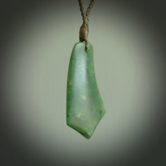 This picture shows a medium sized hand carved jade drop pendant by Ric Moor. The jade is a wonderful deep green. It is suspended from a khaki adjustable cord. Delivery is free worldwide.