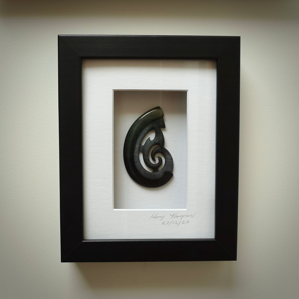 A hand carved large New Zealand Jade Hook, Matau, necklace that has been framed and signed by artist Kerry Thompson. A large sized hand made hook necklace by New Zealand artist Kerry Thompson. One off framed work of art to wear. Delivered with Express Courier.