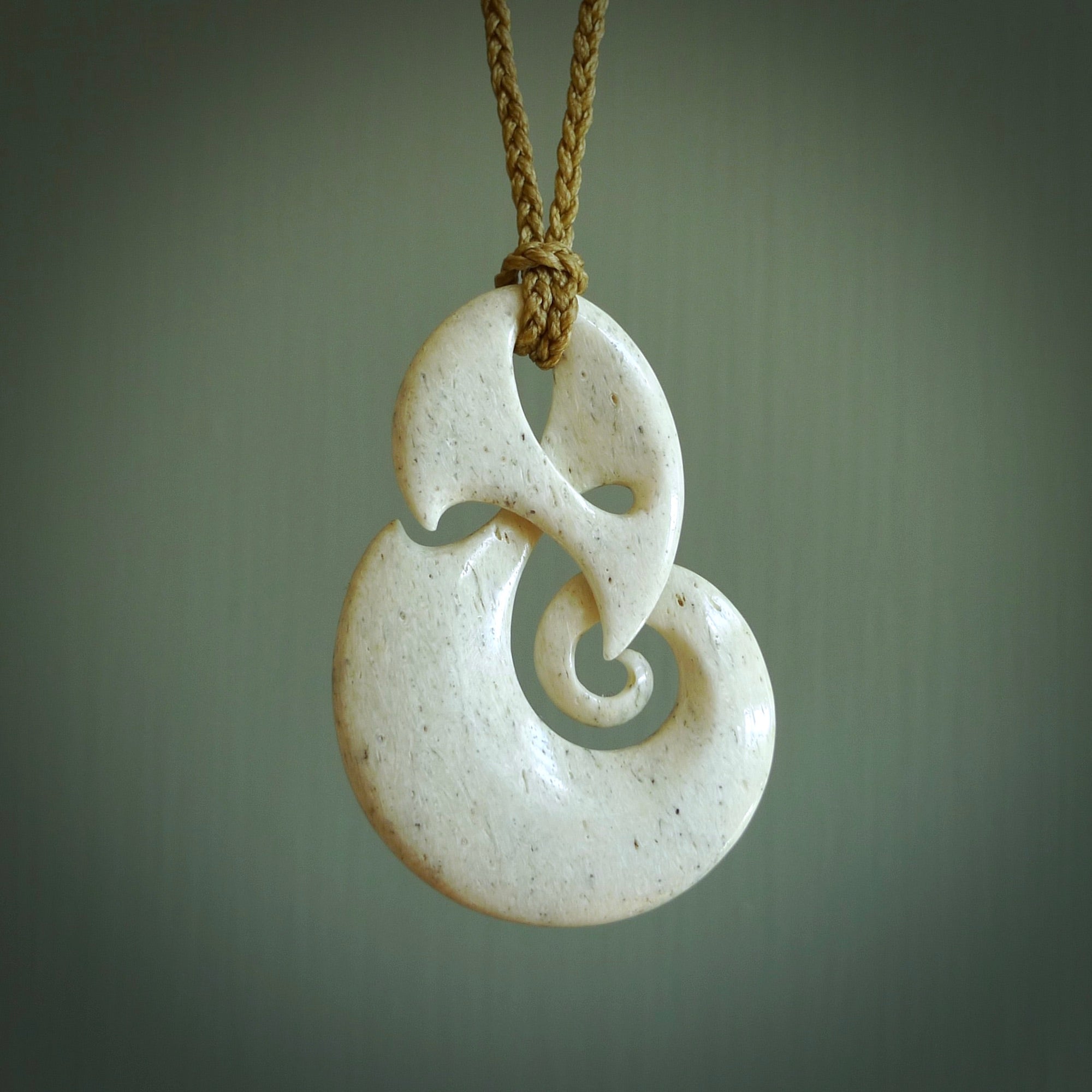 A hand carved path of life design pendant from Whale Bone. The cord tan and is adjustable. Large hand made Koru necklaces by New Zealand artist Kerry Thompson.