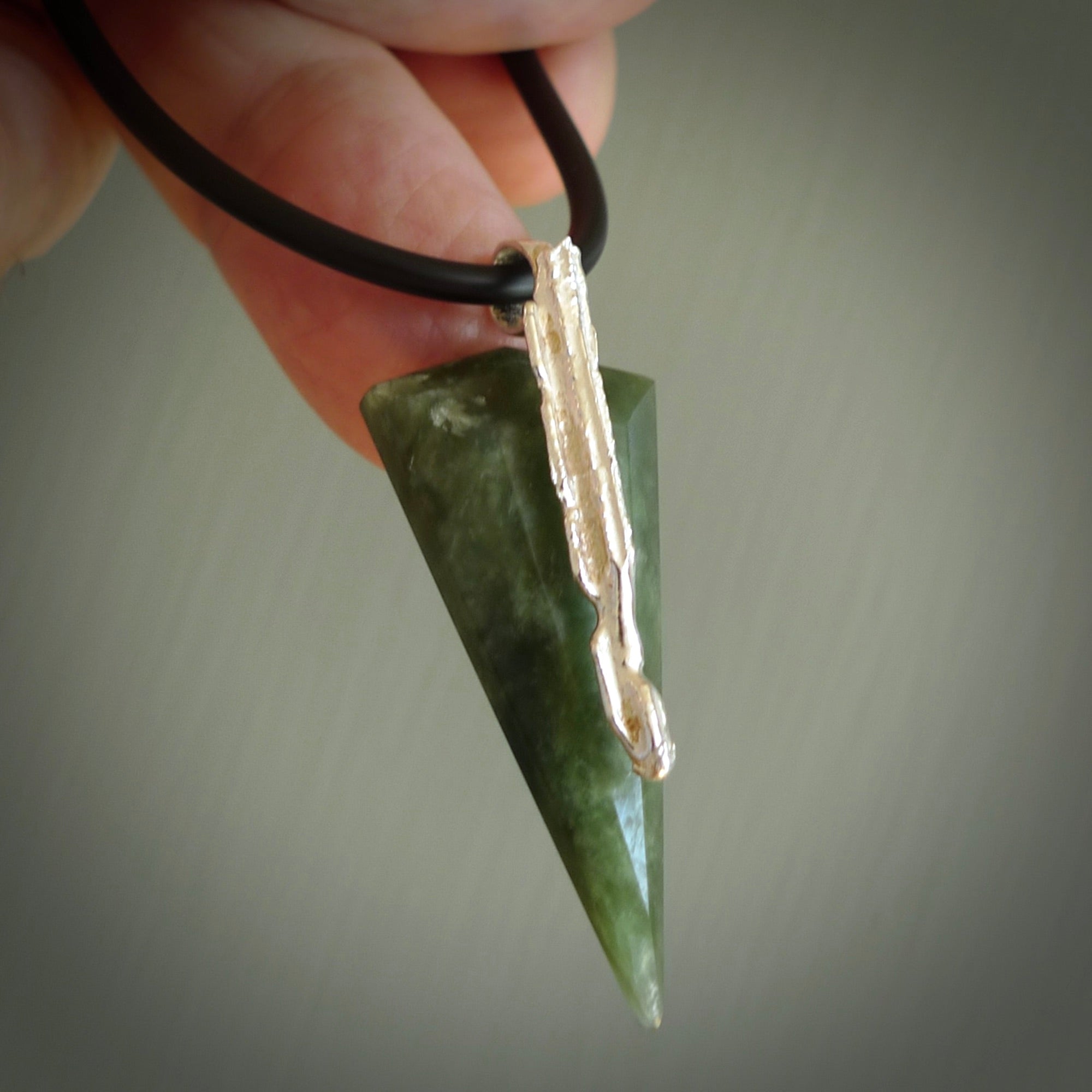 A photo of a New Zealand Jade drop pendant with sterling silver. This is a stylish statement piece - hand crafted here in New Zealand by Ana Krakosky. Unique Art to Wear. Gifts for all lovers of hand made Art to Wear.