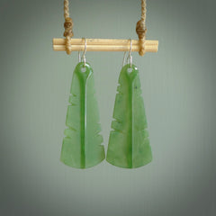 This picture shows New Zealand Pounamu, jade feather earrings with sterling silver hooks. Hand made unique and contemporary feather earrings by Kerry Thompson. Hand carved here in New Zealand from New Zealand Jade. One pair only.