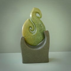 Hand carved New Zealand Flower Jade Hook with Greywacke stand sculpture. Hand carved in New Zealand by Ric Moor. This is a one only sculpture and is a beautiful, large, display piece.