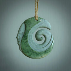 A hand carved koru with face pendant from New Zealand Pounamu, Jade. The cord is Tan and is adjustable. A large hand made Koru necklace by New Zealand artist Kerry Thompson.