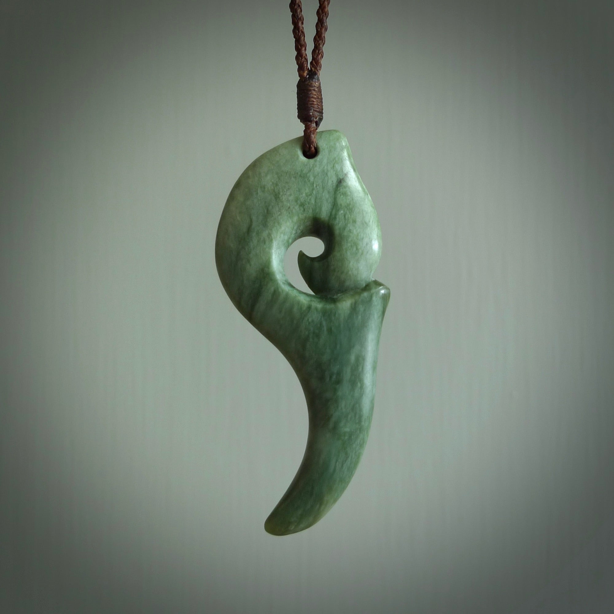 Hand carved huia bird skull made from New Zealand Marsden Jade pendant. Carved for NZ Pacific by Kyohei Noguchi. This is a contemporary piece of jewellery that is carved with intricate detail and clearly shows a beautiful bird skull. We ship this free worldwide with DHL Express Courier.