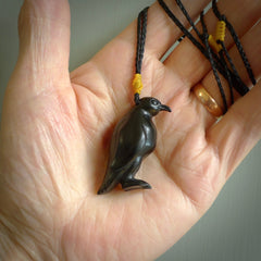 This pendant is a hand carved YELLOW EYED penguin. We've carved this from a lovely piece of black jade and we provide it with a hand plaited cord. Shipping is free worldwide.