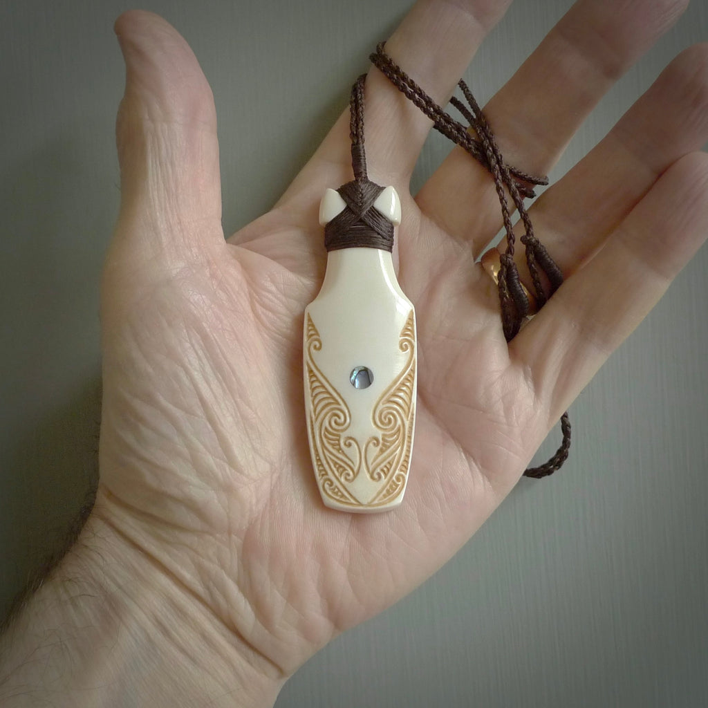 HAND CARVED BONE ENGRAVED TOKI NECKLACE. HAND MADE BONE TOKI