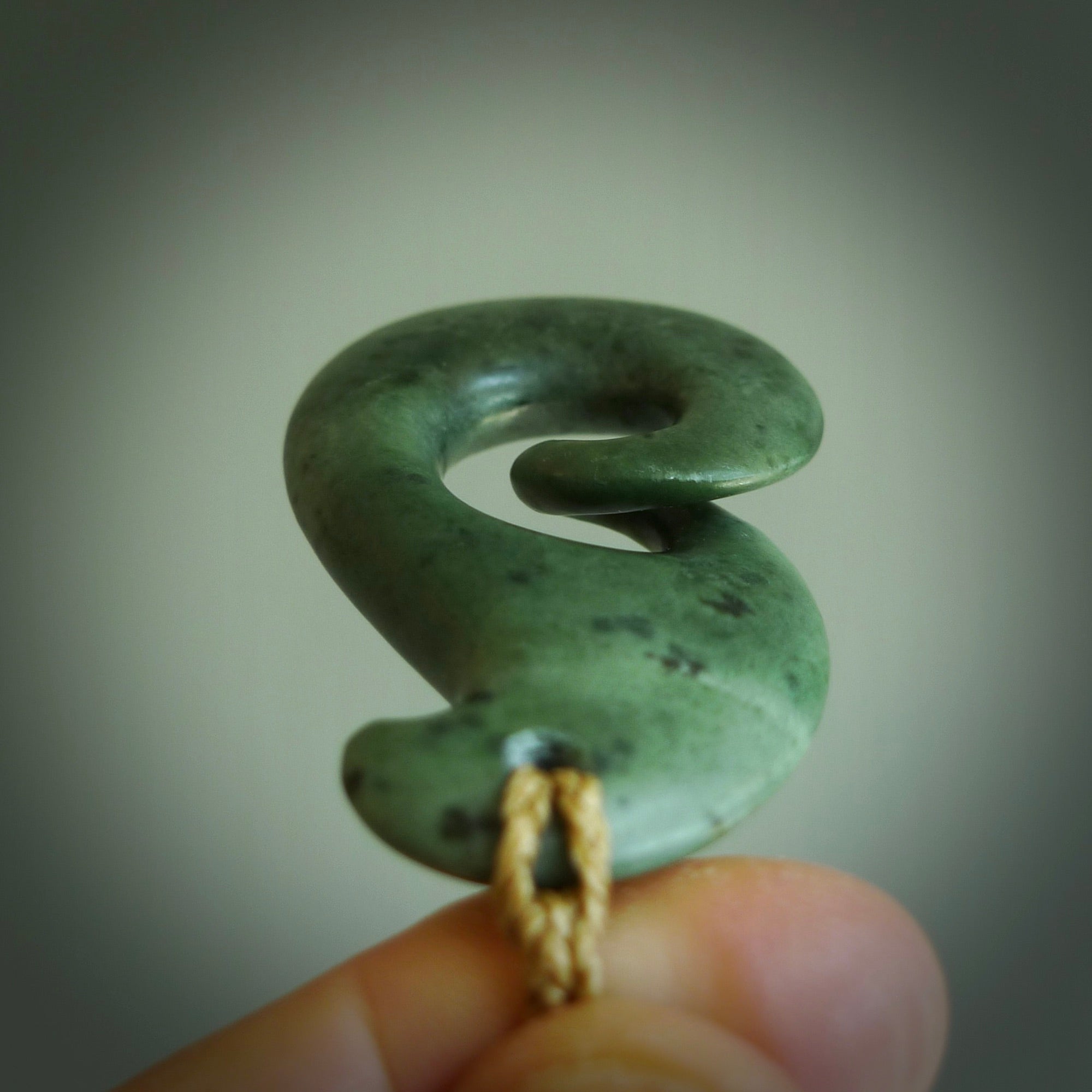 A hand carved koru pendant from New Zealand Jade. The cord is a tan colour and is adjustable. A large hand made Koru necklace by New Zealand artist Kerry Thompson.