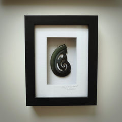 A hand carved large New Zealand Jade koru necklace that has been framed and signed by artist Kerry Thompson. A large sized hand made koru necklace by New Zealand artist Kerry Thompson. One off framed work of art to wear. Delivered with Express Courier.