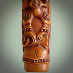 A traditional hand carved Māori Kōauau flute. This piece is made from bone and is a fully functioning musical instrument and can be played. Beautiful ethnic art hand made by NZ Pacific. One only traditional flute by Yuri Terenyi.