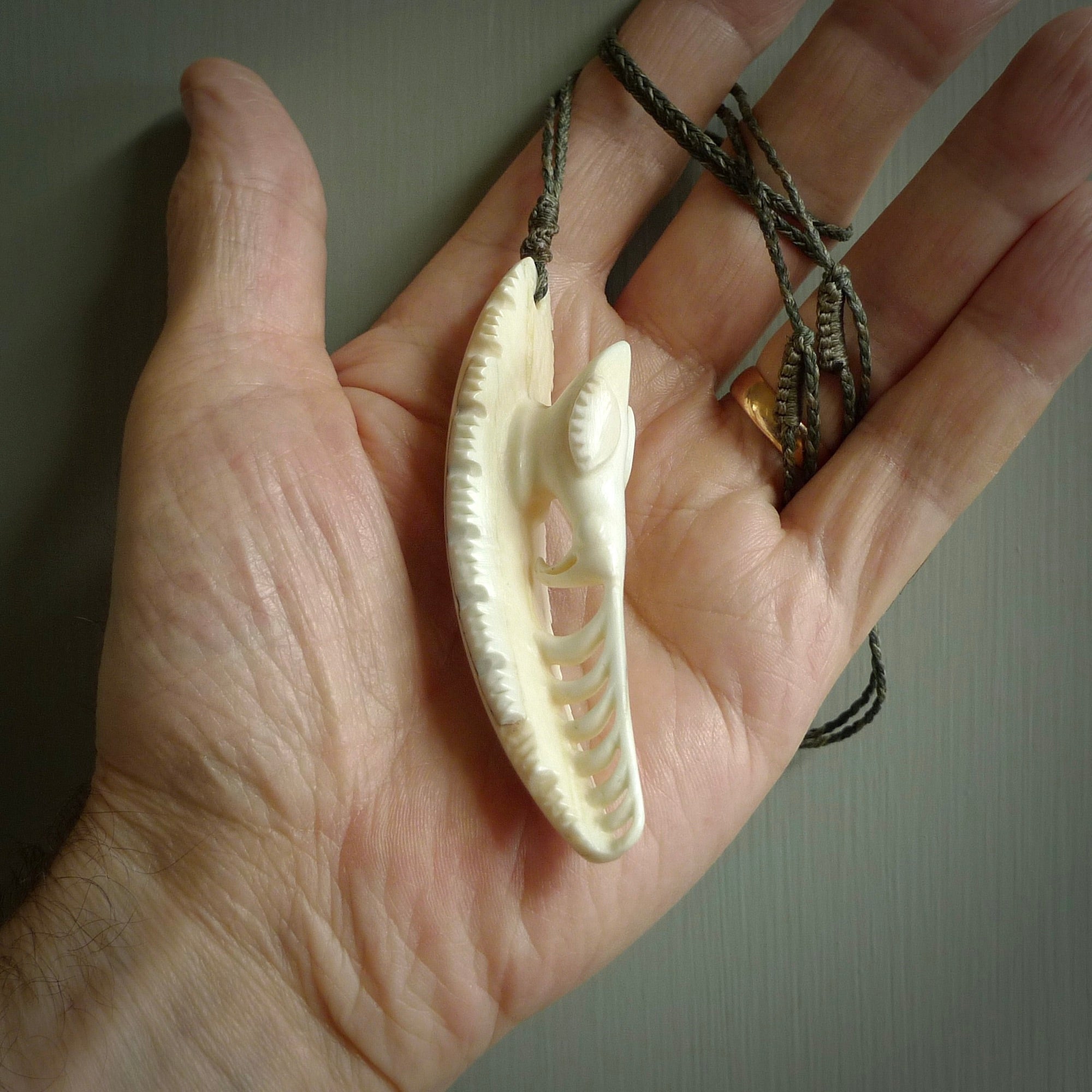 This is a hand carved bone contemporary warthog tusk pendant. Yuri Terenyi has carved this from warthog tusk. It is a delightful, large and artistic piece of jewellery. One only necklace.