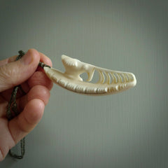 This is a hand carved bone contemporary warthog tusk pendant. Yuri Terenyi has carved this from warthog tusk. It is a delightful, large and artistic piece of jewellery. One only necklace.