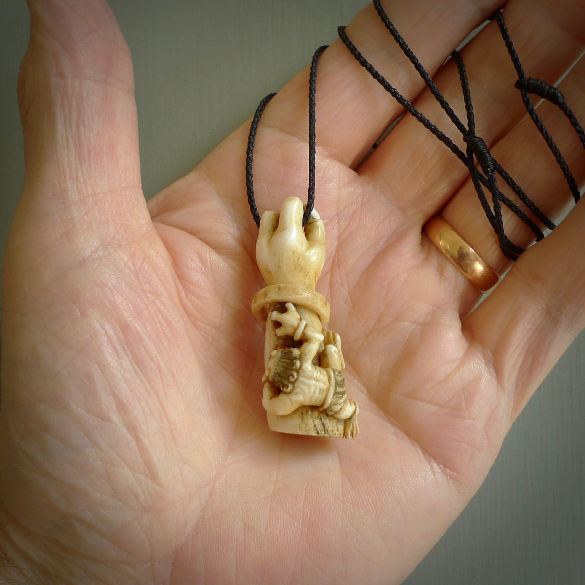 Hand carved Rashōmon Pendant. Made from Red Deer antler in New Zealand. Unique Japanese necklace hand made from deer antler by master bone carver Fumio Noguchi. Spectacular collectable work of art, made to wear. One only pendant, delivered to you at no extra cost with express courier.