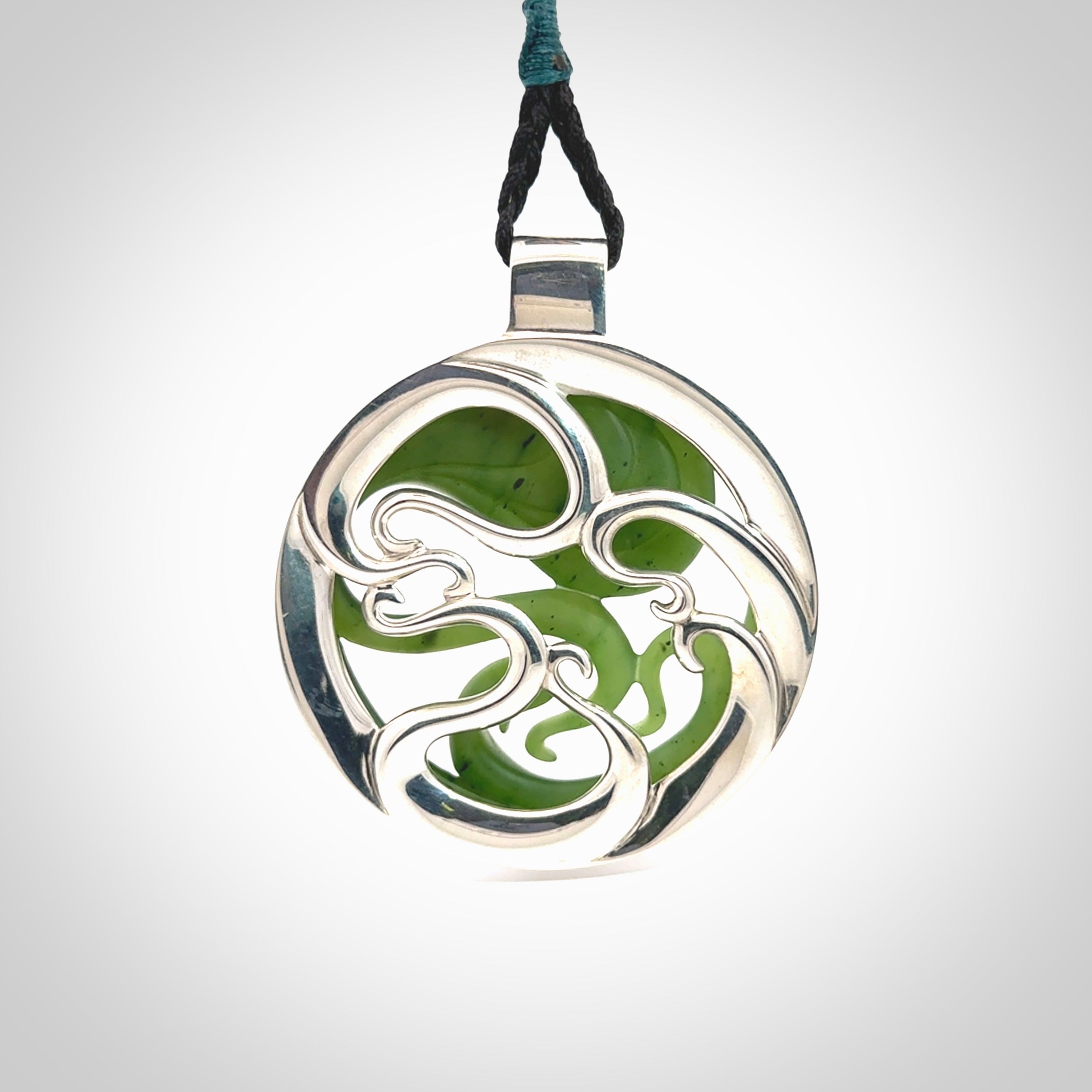 A hand carved New Zealand Jade and Sterling Silver Octopus pendant with Opal eye. Hand made by New Zealand artist Kerry Thompson.