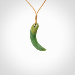 Hand carved pounamu drop pendant. Jade necklace hand made in New Zealand. A contemporary drop pendant carved from rare New Zealand flower jade. NZ Pacific jade jewellery for sale online. Provided with adjustable beige cord and packaged in a woven kete pouch.