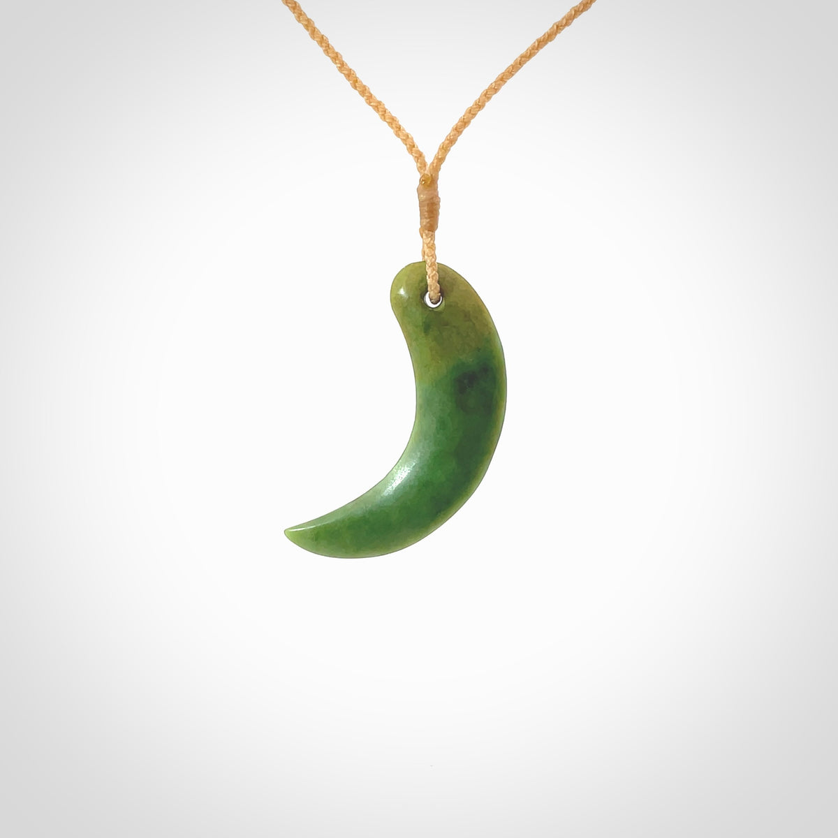 Hand carved pounamu drop pendant. Jade necklace hand made in New Zealand. A contemporary drop pendant carved from rare New Zealand flower jade. NZ Pacific jade jewellery for sale online. Provided with adjustable beige cord and packaged in a woven kete pouch.