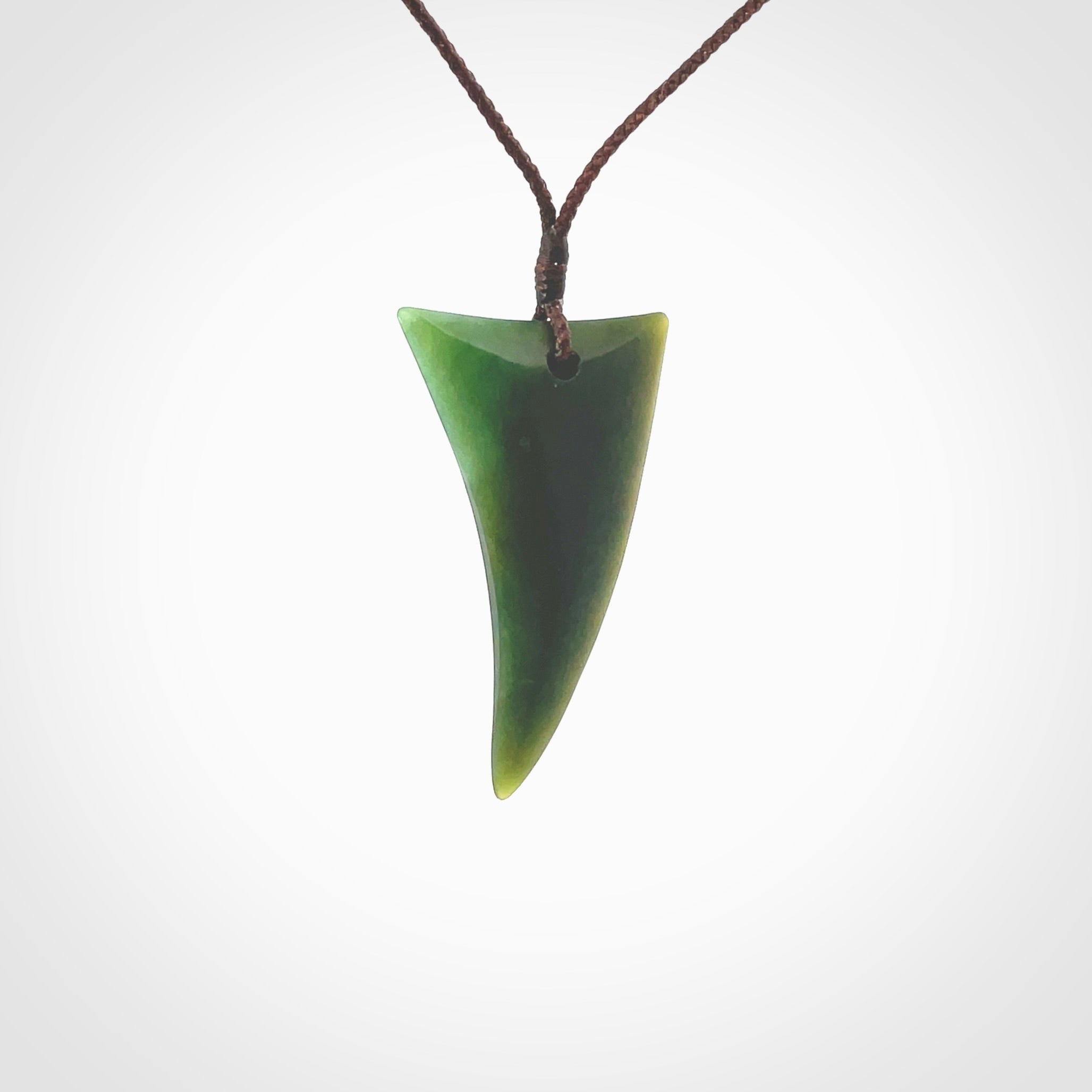 This is a lovely New Zealand Jade, pounamu drop pendant. Hand carved for us by Ric Moor. It is bound with an adjustable brown coloured cord which is length adjustable. Free worldwide shipping.