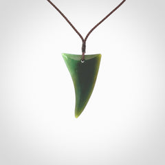 This is a lovely New Zealand Jade, pounamu drop pendant. Hand carved for us by Ric Moor. It is bound with an adjustable brown coloured cord which is length adjustable. Free worldwide shipping.