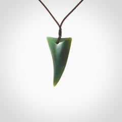 This is a lovely New Zealand Jade, pounamu drop pendant. Hand carved for us by Ric Moor. It is bound with an adjustable brown coloured cord which is length adjustable. Free worldwide shipping.