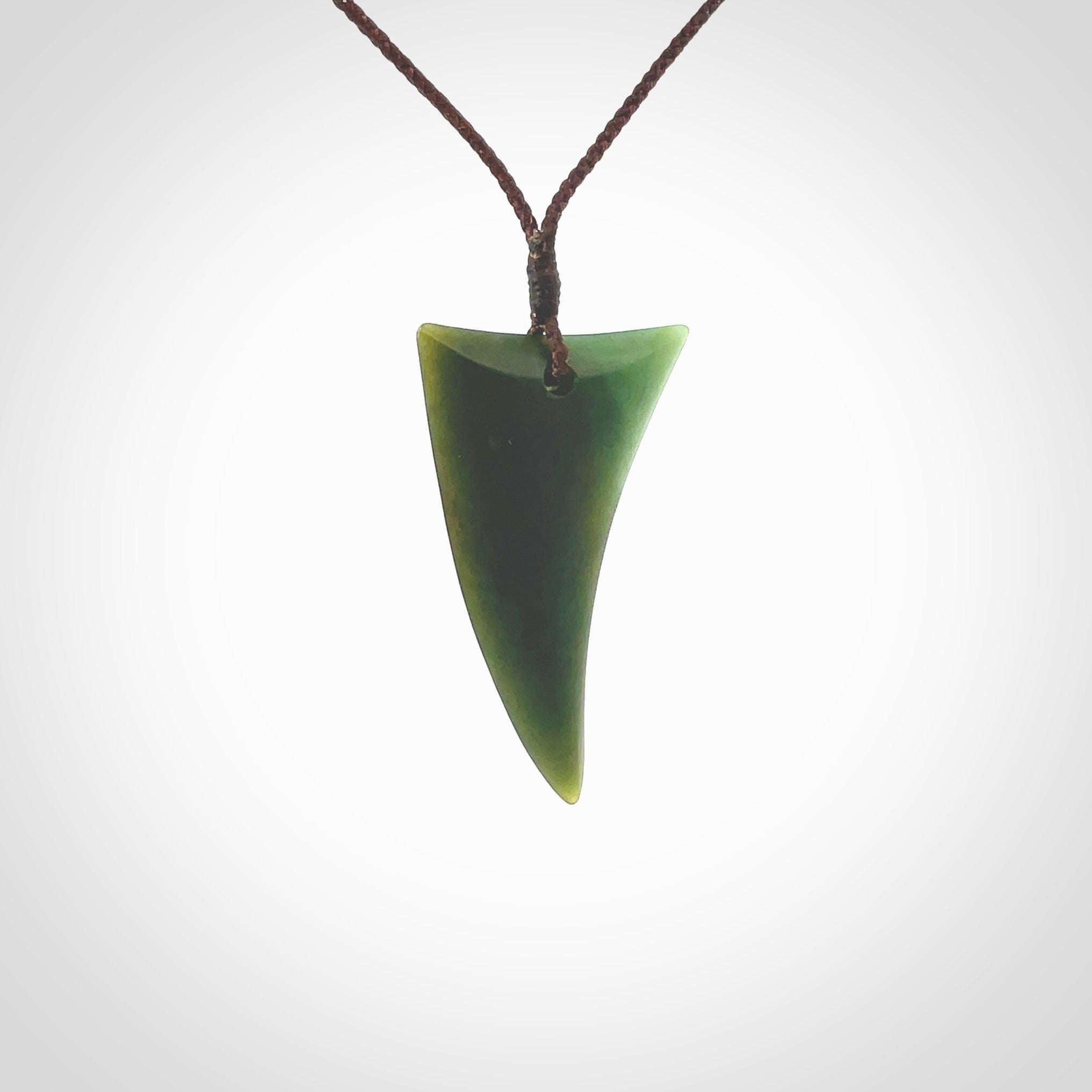 This is a lovely New Zealand Jade, pounamu drop pendant. Hand carved for us by Ric Moor. It is bound with an adjustable brown coloured cord which is length adjustable. Free worldwide shipping.