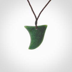 Hand carved pounamu drop pendant. Jade necklace hand made in New Zealand. A contemporary drop pendant carved from rare New Zealand jade. NZ Pacific jade jewellery for sale online. Provided with adjustable brown cord.