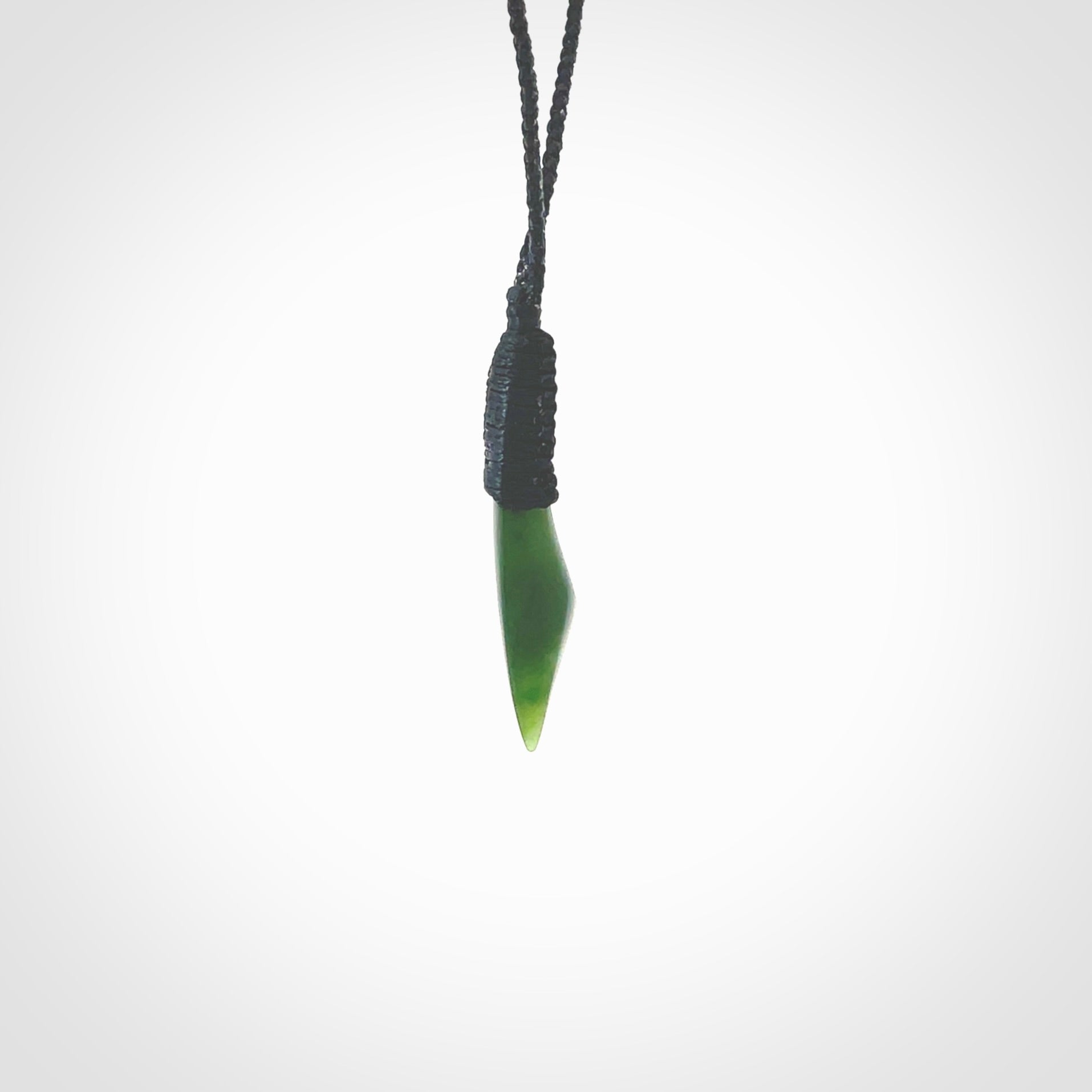 A lovely small sized New Zealand jade drop pendant. This piece is made from a semi-translucent jade and is a wonderful deep green colour. Carved by Ric Moor for NZ Pacific and delivered worldwide. Provided with an adjustable black cord.