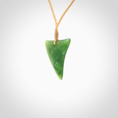 One only medium sized New Zealand jade drop pendant. Hand carved in New Zealand by Ric Moor, jade artist, for NZ Pacific. Provided with adjustable beige cord.