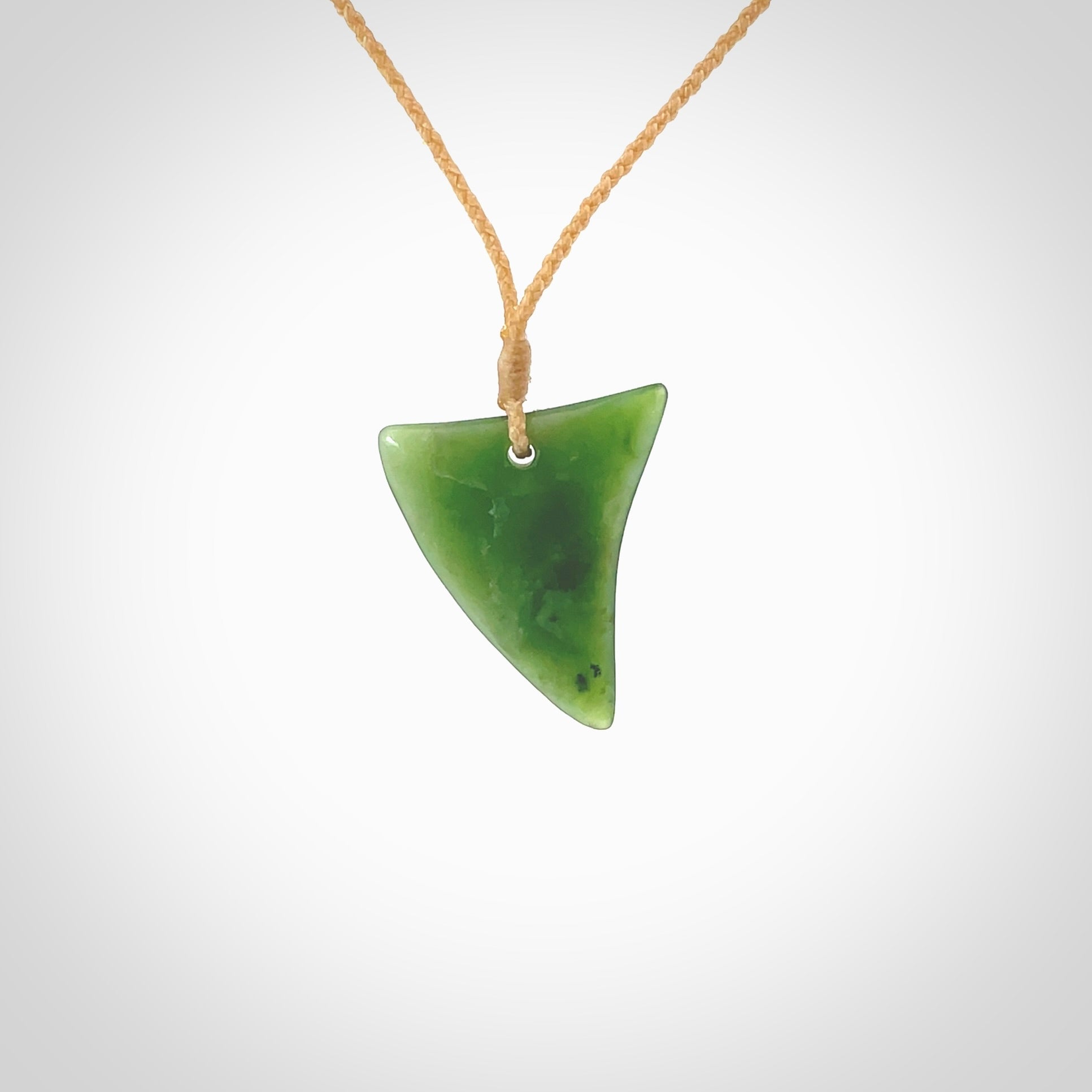 One only medium sized New Zealand jade drop pendant. Hand carved in New Zealand by Ric Moor, jade artist, for NZ Pacific. Provided with adjustable beige cord.