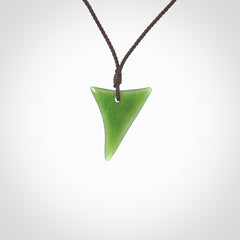 One only small sized New Zealand jade drop pendant. Hand carved in New Zealand by Ric Moor, jade artist, for NZ Pacific. Provided with adjustable brown cord.