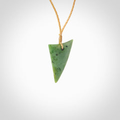 This is a lovely New Zealand Jade, pounamu drop pendant. Hand carved for us by Ric Moor. It is bound with an adjustable beige coloured cord which is length adjustable. Free worldwide shipping.