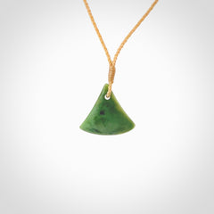 This is a lovely New Zealand Jade, pounamu drop pendant. Hand carved for us by Ric Moor. It is bound with an adjustable beige coloured cord which is length adjustable. Free worldwide shipping.