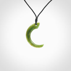 Hand carved pounamu drop pendant. Jade necklace hand made in New Zealand. A contemporary drop pendant carved from rare New Zealand jade. NZ Pacific jade jewellery for sale online. Provided with adjustable black cord and packaged in a woven kete pouch.